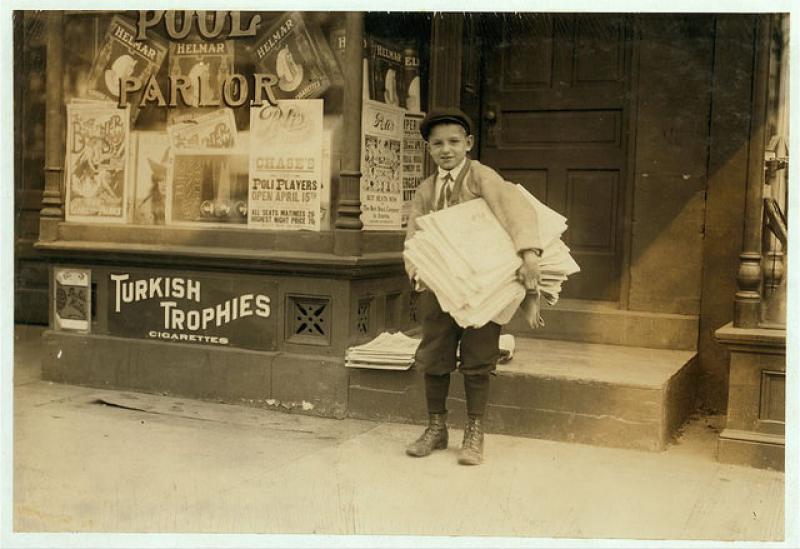 Washington, D.C., a ten year old newsie from a good family, carrying a heavy load of newspapers quite a distance.