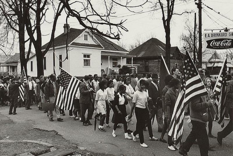 Participants, some carrying American flags, marching in the civil rights march from Selma to Montgomery, Alabama in 1965