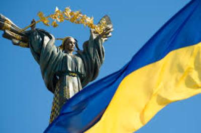 Ukrainian statue of woman with Ukraine flag in corner of image